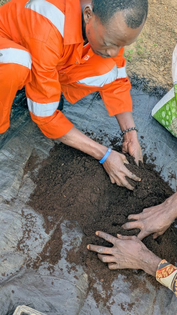 Picture of an FMS farmer sorting through the soil